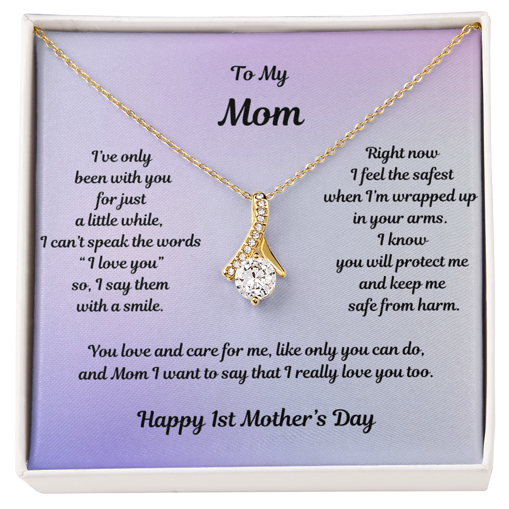 Yellow Gold Alluring Beauty Necklace Drop Pendant Style with a Large CZ crystal in center and small crystals accenting. Message reads: To My Mom: I've only been with you for just a little while, I can't speak the words "I love you" so I say them with a smile. Right now I feel the safest when I'm wrapped up in your arms. I know you will protect me and keep m safe from harm. You love and care for me, like only you can do, and Mom I want to say that I really love you too. Happy 1st Mother's Day.