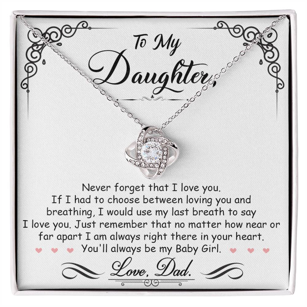 White Gold Love Knot Necklace with a large CZ crystal in center, surrounded by smaller crystals. Shown in Standard Gift Box. Message reads: To My Daughter: Never forget that I love you. If I had to choose between loving you and breathing, I would use my last breath to say I love you. Just remember that no matter how near or far apart I am always right there in your heart. You'll always be my baby girl. Love, Dad