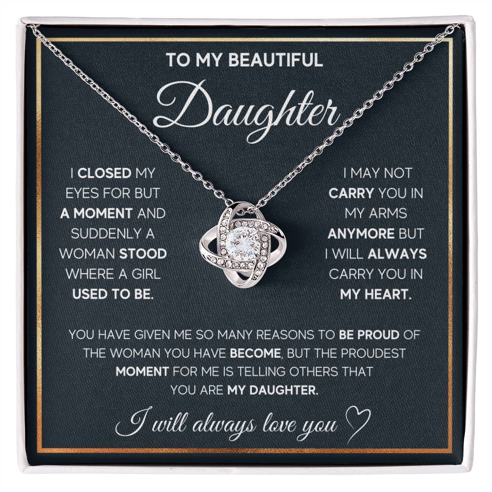 White Gold Love Knot Necklace featuring a large center CZ, surrounded by smaller crystals. Shown in the Standard Gift Box. Message reads: To My Beautiful Daughter: I closed my eyes for a moment and suddenly a woman stood where a girl used to be. I may not be able to carry you in my arms anymore but I will always carry you in my heart. You have given me so many reasons to be proud of the woman you have become, but the proudest moment for me is telling others that you are my daughter. I will always love you