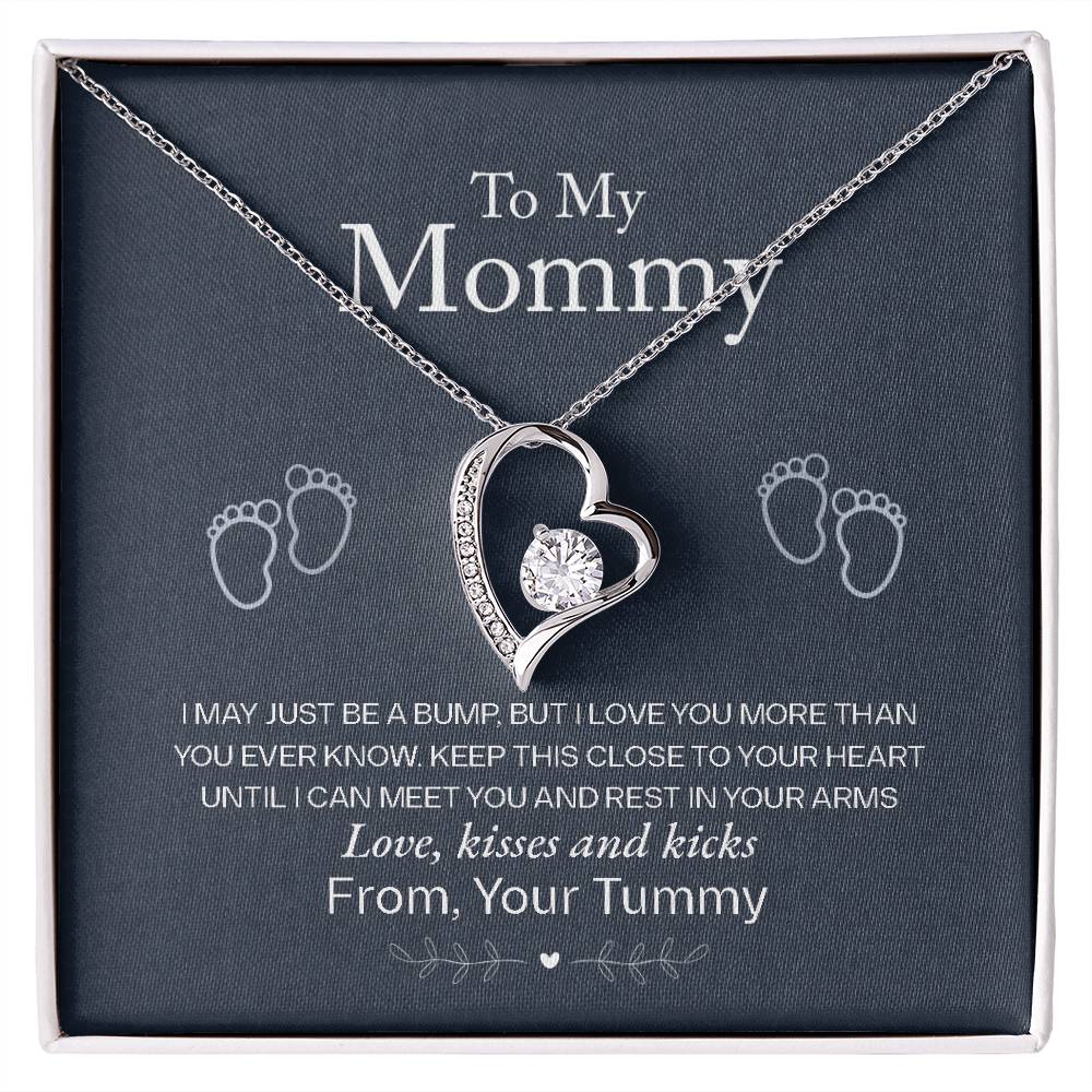 Silver Heart Necklace with Cubic Zirconia in Center and Small Stones on one side. Standard Gift Box. Message Card reads: To My Mommy: I may just be a bump. But I love you more than you ever know. Keep this close to your heart until I can meet you and rest in your arms. Love, kisses and kicks From, Your Tummy - Givethegifts.com