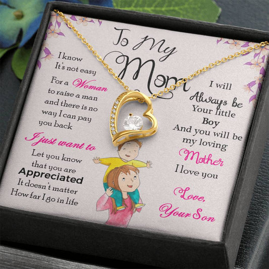 Gold Heart Necklace with Cubic Zirconia in Center and small stones on one side of the heart. Black Gift Box. Message card behind it shows a mom with a little boy on her shoulders. Card reads: To My Mom: I know it's not easy for a woman to raise a man and there is no way I can pay you back. I just want you to know that you are appreciated. It doesn't matter how far I go in life I will always be your little boy and you will always be my loving mother. I love you. Love, your son. - Givethegifts.com