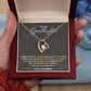 Yellow Gold Forever Love Heart Necklace with large CZ crystal at the center and maller crystals on one side. Shown in Luxury Gift Box. Message reads: To My Granddaughter: I hugged this little pendant, I squeezed it really tight. I filled it with my wishes, hope and love and light. So when you're feeling low just hold it really tight. You'll feel my love within it morning, noon, and night. Love, Grandma