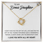 Yellow Gold Love Knot Necklace with Large CZ crystal in center, urrounded by smaller crystals. Shown in Standard Gift Box. Message card reads: To My Bonus Daughter: I didn't give you the gift of life, life gave me the gift of you. Thanks fo rbeing such a wonderful person, always shine like the brightest star. I love you with all my heart.