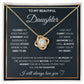 Yellow Gold Love Knot Necklace featuring a large center CZ, surrounded by smaller crystals. Shown in the Standard Gift Box. Message reads: To My Beautiful Daughter: I closed my eyes for a moment and suddenly a woman stood where a girl used to be. I may not be able to carry you in my arms anymore but I will always carry you in my heart. You have given me so many reasons to be proud  of the woman you have become, but the proudest moment for me is telling others that you are my daughter. I will always love you