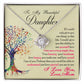 White Gold Love Knot Necklace with a large CZ crystal at the center surrounded by smaller crystals. Shown in a Standard Gift Box. Message card reads :To My Beautiful Daughter: If I could only give you one thing in this life, I would give you the ability to see yourself how I see you every single day. Your beauty, your kindness, how happy you make me and how proud I am of you. Perhaps then you would be able to understand just how special you are to me. I love you, Love, Mom. With a colorful image of a tree.
