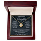 Yellow Gold Love Knot Necklace featuring a large center CZ, surrounded by smaller crystals. Shown in the Luxury Gift Box. Message reads: To My Beautiful Daughter: I closed my eyes for a moment and suddenly a woman stood where a girl used to be. I may not be able to carry you in my arms anymore but I will always carry you in my heart. You have given me so many reasons to be proud  of the woman you have become, but the proudest moment for me is telling others that you are my daughter. I will always love you. 