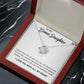 White Gold Love Knot Necklace with Large CZ crystal in center, urrounded by smaller crystals. Shown in Luxury Gift Box. Message card reads: To My Bonus Daughter: I didn't give you the gift of life, life gave me the gift of you. Thanks fo rbeing such a wonderful person, always shine like the brightest star. I love you with all my heart.