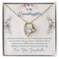 Yellow Gold Forever Love Heart Necklace with large CZ crystal in center, and smaller crystals along one side. Shown in Standard Gift Box. Message reads:To My Granddaughter: When life tries to knock you down, this old woman will always have your back. I hope you believe in yourself as much as I believe in you. I love you for all that you are, all that you have been, and all that you are yet to be. Love, Your Grandmother.