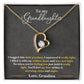 Yellow Gold Forever Love Heart Necklace with large CZ crystal at the center and maller crystals on one side. Shown in Standard Gift Box. Message reads: To My Granddaughter: I hugged this little pendant, I squeezed it really tight. I filled it with my wishes, hope and love and light. So when you're feeling low just hold it really tight. You'll feel my love within it morning, noon, and night. Love, Grandma