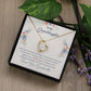 Yellow Gold Forever Love Heart Necklace with large CZ crystal in center, and smaller crystals along one side. Shown in Standard Gift Box. Message reads:To My Granddaughter: When life tries to knock you down, this old woman will always have your back. I hope you believe in yourself as much as I believe in you. I love you for all that you are, all that you have been, and all that you are yet to be. Love, Your Grandmother.