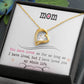 Gold heart necklace with cubic zirconia in the center and several smaller stones on one side. Shown in standard gift box. Message reads: Mom You have loved me for as long as I have lived, but I have loved you my whole life.