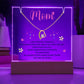 Clear Acrylic Plaque with the saying Mom - I am forever thankful for everything you are and all that you do. Your endless love. Your unwavering strength. the memories we share and for always being there. You are so loved. (Corded base, purple led light illuminated, color can be adjusted) There are two notches in the top of the plaque where the forever heart necklace is placed. 18K yellow gold plated heart, with a large single cubic zurconia in the center and several smaller stones on one side.