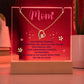 Clear Acrylic Plaque with the saying Mom - I am forever thankful for everything you are and all that you do. Your endless love. Your unwavering strength. the memories we share and for always being there. You are so loved. (Cordless base, red led light illuminated, color can be adjusted) There are two notches in the top of the plaque where the forever heart necklace is placed. 18K yellow gold plated heart, with a large single cubic zurconia in the center and several smaller stones on one side.